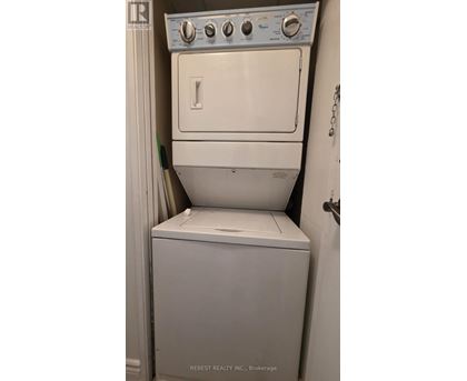 A white dryer and washer in a small room.