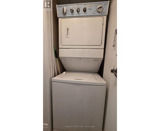 A white dryer and washer in a small room.
