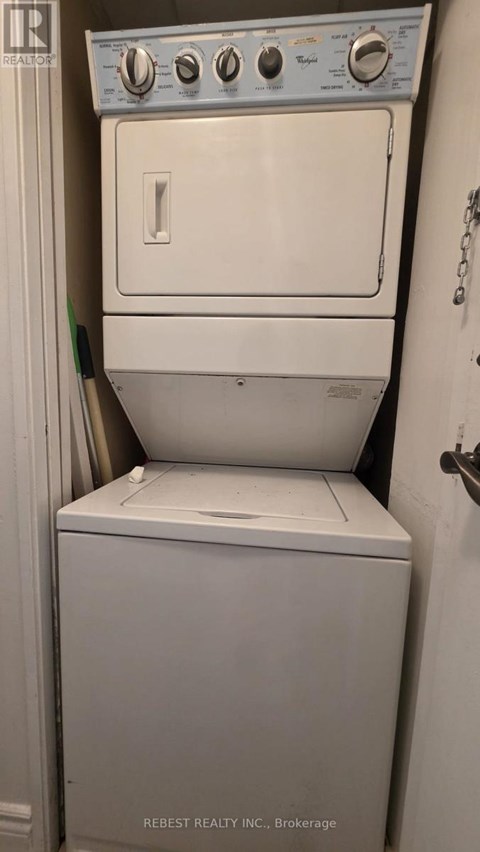 A white dryer and washer in a small room.