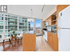 A kitchen with a table and chairs in front of a window with a view of a cityscape.