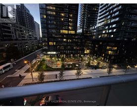 A cityscape at night with a building that has a "REALTOR" sign on it.