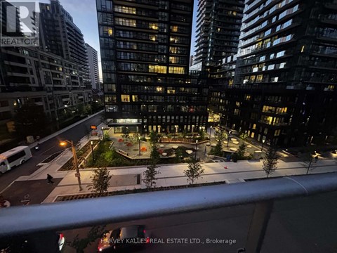 A cityscape at night with a building that has a "REALTOR" sign on it.