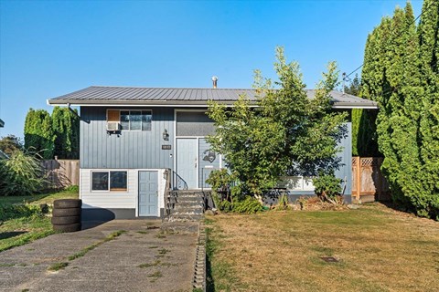 A grey house with a grey roof and a grey door.