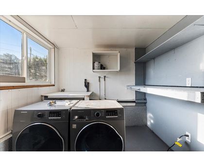 Two front loading washing machines in a laundry room.