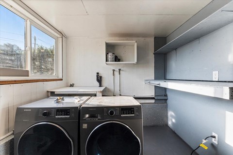 Two front loading washing machines in a laundry room.