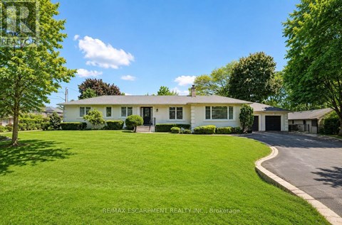 A white house with a green lawn in front.