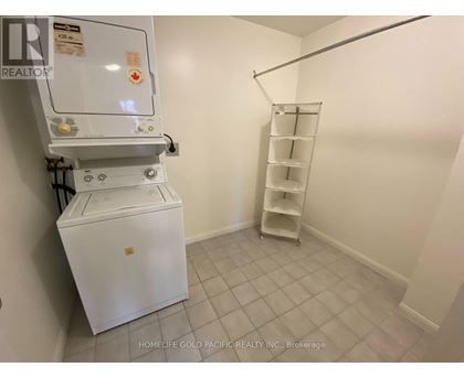 A white refrigerator in a room with a shelf.