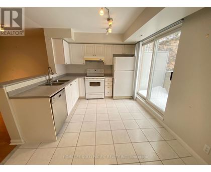 A kitchen with white appliances and a white refrigerator.