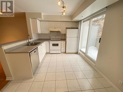 A kitchen with white appliances and a white refrigerator.