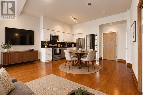 A modern kitchen with a dining table set in the middle.