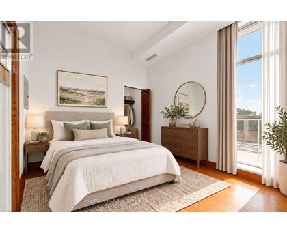 A bedroom with a large bed, a painting on the wall, and a round mirror on the dresser.