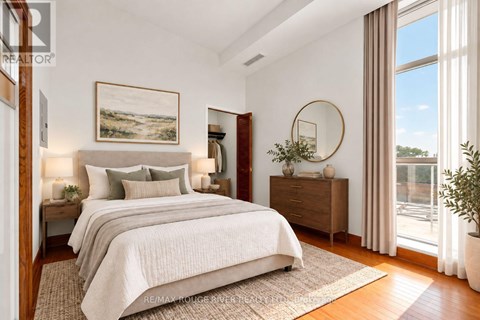 A bedroom with a large bed, a painting on the wall, and a round mirror on the dresser.
