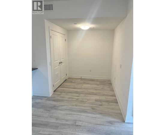 A hallway with a wooden floor and white walls.