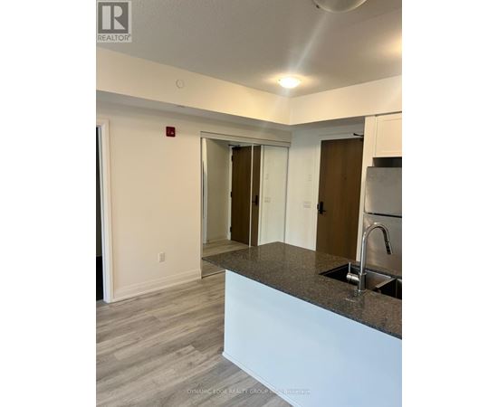 A kitchen area with a sink and a counter.