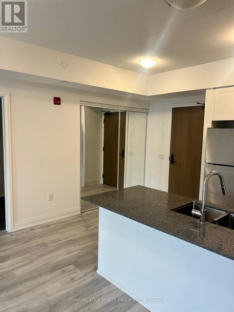 A kitchen area with a sink and a counter.