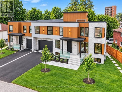 A modern two-story house with a garage and a driveway.