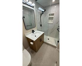 A bathroom with a sink, toilet, and shower.