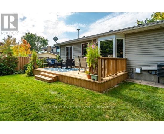 A backyard with a deck and a hot tub.