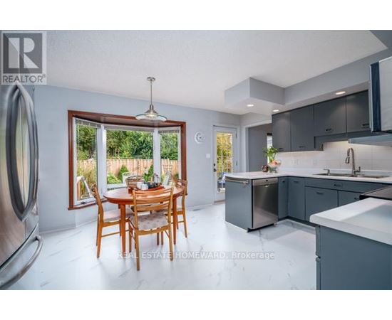 A modern kitchen with a dining table and chairs in the foreground.