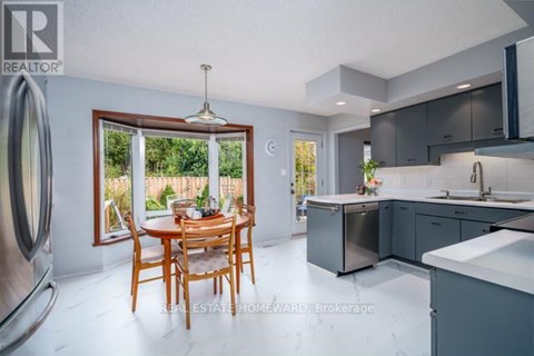 A modern kitchen with a dining table and chairs in the foreground.