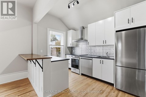 A kitchen with white cabinets and a wooden countertop.