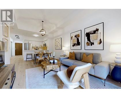 A living room with a grey couch and a wooden coffee table.