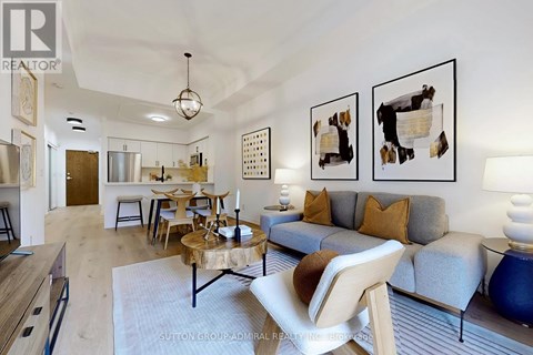 A living room with a grey couch and a wooden coffee table.