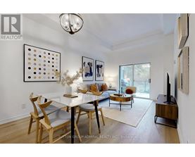 A dining room with a white table and chairs.
