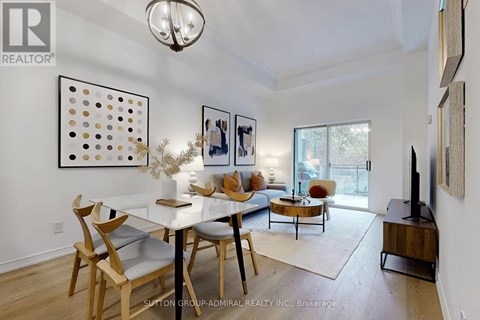 A dining room with a white table and chairs.