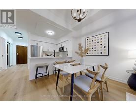 A modern kitchen with a dining table and chairs.