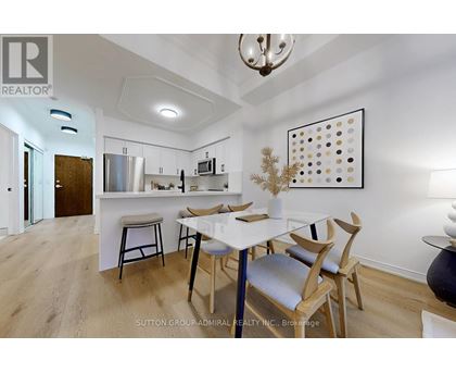 A modern kitchen with a dining table and chairs.