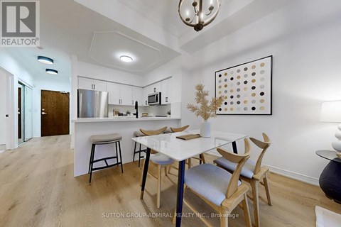 A modern kitchen with a dining table and chairs.