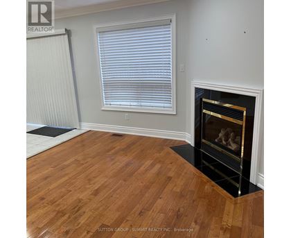 A room with a fireplace and wooden floors.