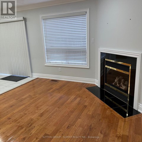 A room with a fireplace and wooden floors.