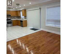 A kitchen with wooden cabinets and a white refrigerator.