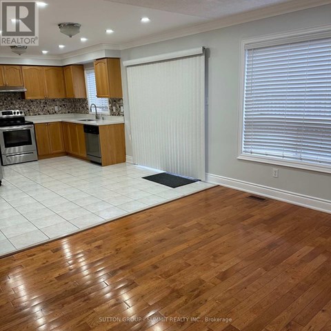 A kitchen with wooden cabinets and a white refrigerator.
