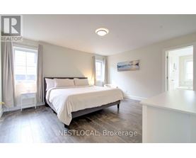 A bedroom with a large bed and a window with curtains.
