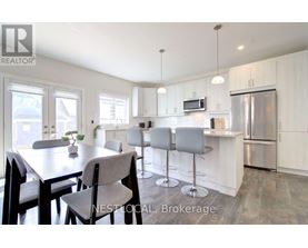 A modern kitchen with a dining table and chairs.