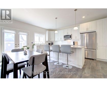 A modern kitchen with a dining table and chairs.