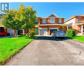 A residential street with a house and a parked car.