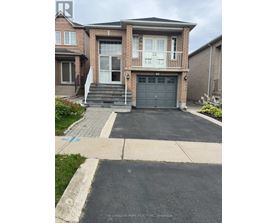 A house with a driveway in front of it.
