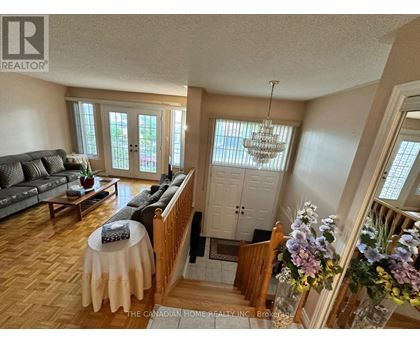 A living room with a grey couch and a wooden table.