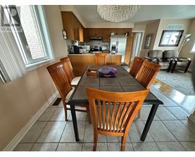 A dining room with a table and chairs.