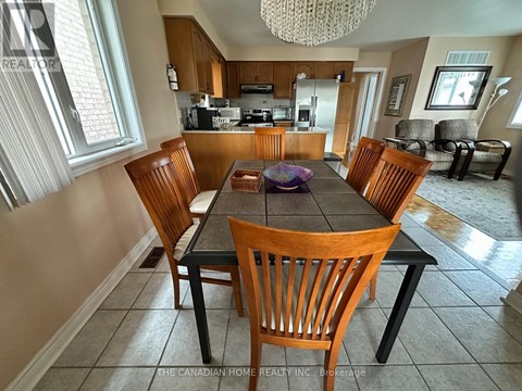 A dining room with a table and chairs.