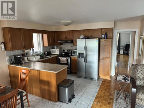 A kitchen with wooden cabinets and a refrigerator.