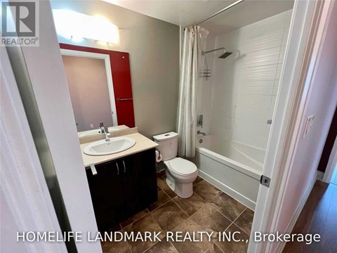 A bathroom with a sink, toilet, and bathtub.