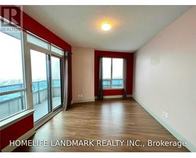 A room with a sliding glass door leading to a balcony.