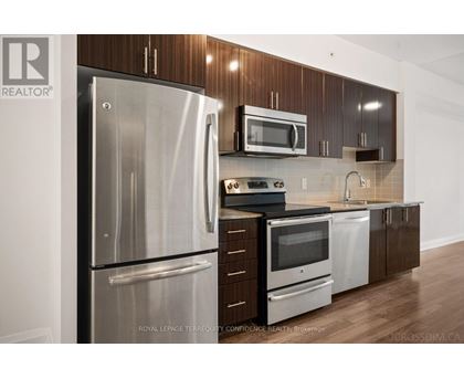A kitchen with a stainless steel refrigerator and microwave.