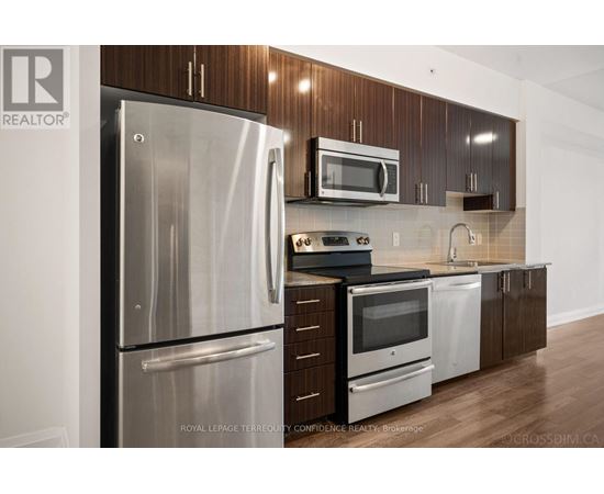 A kitchen with a stainless steel refrigerator and microwave.