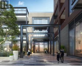A modern building entrance with people walking in and out.